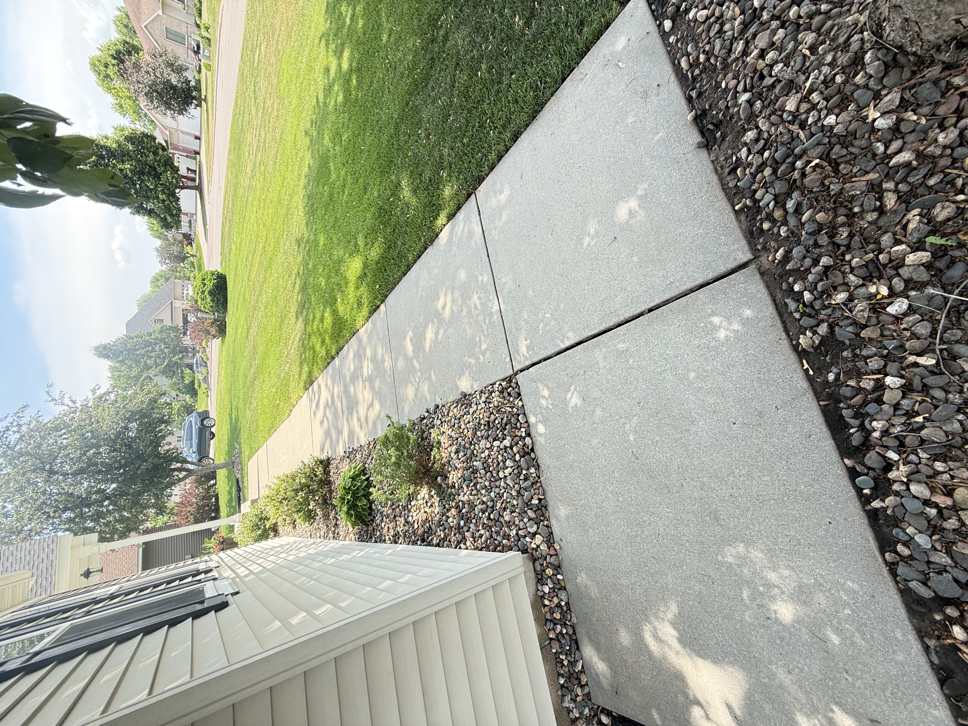 Clean bright concrete driveway after pressure washing